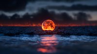 Red full moon rising over dark ocean waves at night, dramatic blood moon reflection on water surface creates mystical atmosphere with stormy clouds.