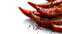 Fresh red chili peppers with spice seasoning on white background for culinary cooking and hot food preparation.