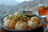 Steamed dumplings with spicy minced meat topping served on traditional plate with dipping sauce and iced tea, mountain landscape background.