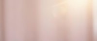 Soft blurred gradient background transitioning from warm beige to pale pink tones, creating a serene and minimalist aesthetic suitable for design overlays.
