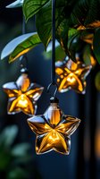 Glowing star-shaped glass lanterns hanging from green foliage create magical garden atmosphere with warm golden light against dark background. Perfect for holiday decor.