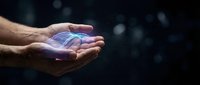 Caucasian male hand holding glowing blue digital hologram against dark background, representing technology, innovation, and future digital solutions.