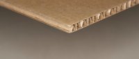 Corrugated cardboard sheet edge showing honeycomb structure detail for packaging and shipping materials in manufacturing industry applications.
