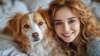 Young Caucasian woman with curly blonde hair and bright smile posing with friendly brown and white mixed breed dog in cozy home setting.