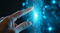 Finger touching digital particles creating glowing blue connection effect against dark background, representing technology interface and future innovation.