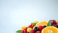 Fresh mixed fruits and berries with mint leaves on white background for healthy eating, nutrition and organic food concepts.