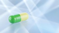 Green and yellow medical capsule pill on clean white background isolated for pharmaceutical healthcare design applications.