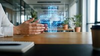 Professional businessman presenting holographic digital technology interface with glowing blue data visualization in modern office workspace environment.