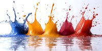 Colorful liquid splashes in blue, orange and red creating dynamic crown shapes with droplets against white background, reflecting on wet surface.