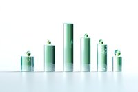 Green glass cylinders of varying heights arranged in ascending and descending order on white surface, creating minimalist composition with reflective elements.