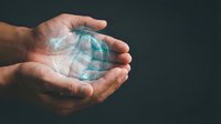 Hands holding glowing digital globe with network connections, representing global business, technology, and worldwide communication for corporate and environmental concepts.
