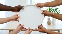 Diverse group of people holding blank white circle together, representing unity, teamwork, collaboration and community support in modern office environment.