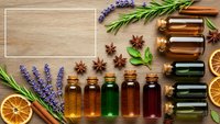 Essential oils collection with lavender, rosemary and citrus on wooden background. Natural aromatherapy bottles for wellness, spa treatments and holistic healing.