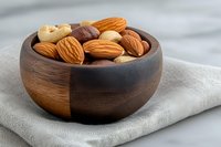 Mixed nuts and dried fruits in wooden bowl on linen cloth, healthy snacking and organic food concept for nutrition and wellness lifestyle.