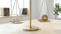 Modern wooden balance scale with gear and house symbols representing work-life balance concept on clean desk in bright office interior.