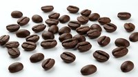 Roasted coffee beans scattered on white background, isolated for cafe menu design, beverage branding and culinary projects.