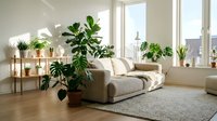 Bright modern living room with beige sofa, potted plants on wooden shelves, large windows with city view, and natural light throughout the space for home decor.