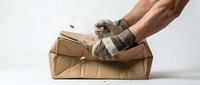 Worker in work gloves opening cardboard box on white background. Suitable for delivery, logistics, warehouse, shipping, and unboxing concepts.