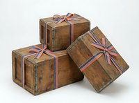 Vintage wooden suitcases with striped ribbon bows isolated on white background, ready for travel, gift, or design projects.