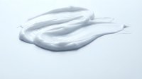 Creamy white cosmetic gel or serum sample with smooth, flowing texture on white background for skincare, beauty product packaging, and cosmetics advertising.