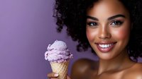 Young African American woman with curly hair smiling while holding purple ice cream cone against lavender background for summer dessert advertising.