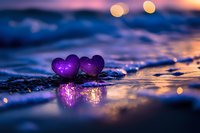 Purple glowing hearts on wet beach sand with ocean waves and bokeh lights creating romantic sunset atmosphere for love and relationship concepts.