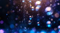 Magical night sky with glowing blue and purple bokeh lights and floating soap bubbles creating dreamy atmospheric effect against dark background.