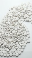 White pharmaceutical tablets and capsules arranged on neutral background, suitable for healthcare, medicine, pharmacy, and medical industry applications.