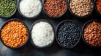 Variety of colorful raw legumes, grains and rice in black bowls on dark background. Healthy protein sources and cooking ingredients for vegetarian food.