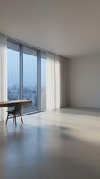 Minimalist modern apartment interior with large windows, wooden desk and chair overlooking urban cityscape with natural light and clean architectural lines.