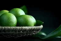Fresh green limes with textured peel in rustic woven basket against dark background, dramatic side lighting creates moody atmosphere for food photography.