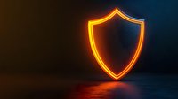 Glowing neon shield symbol on dark background with orange light reflection on surface, security and protection concept for business and technology.