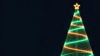 Glowing Christmas tree with golden star and sparkling lights on dark background for holiday greeting cards and festive decorations.
