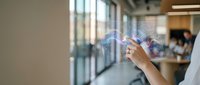 Young Asian businesswoman touching holographic digital interface display in modern office environment for futuristic technology presentations.