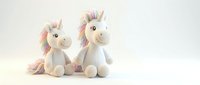 Two plush unicorn toys with rainbow manes and tails, isolated on white background, perfect for children's product design, nursery decor, and merchandise applications.