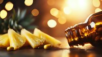 Fresh pineapple slices with macadamia nuts on wooden surface against warm bokeh background, dramatic side lighting creates cozy atmosphere.