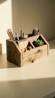 Rustic wooden desk organizer with compartments holding pens, pencils, notepad and small succulent plant in warm natural lighting for office workspace decor.