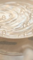 Luxurious cream cosmetic texture with swirling pattern and golden bubbles for skincare and beauty product packaging design.