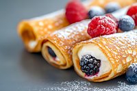 Fresh crepes filled with cream cheese and decorated with ripe berries, dusted with powdered sugar on dark background, close up view of dessert.
