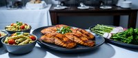 Grilled salmon fillet with fresh herbs served alongside roasted vegetables and salad in modern kitchen setting for healthy dining and culinary content.