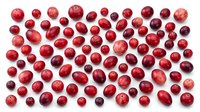 Fresh red cranberries scattered on white background, perfect for healthy eating concepts, holiday cooking recipes, superfood nutrition content.