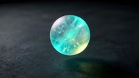 Translucent turquoise and yellow glowing sphere with ethereal light effects on dark textured surface, suitable for fantasy, sci-fi, and digital design projects.