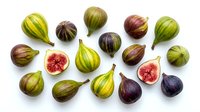 Fresh figs arranged overhead on white background, whole and halved fruits showing pink flesh and seeds, suitable for food photography, culinary content, and healthy eating designs.