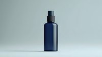 Navy blue glass cosmetic bottle with spray dispenser on light background, minimalist product photography for beauty and skincare packaging design.
