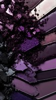 Crushed purple and black eyeshadow palette with shimmering powder texture and metallic stripes creating abstract makeup art composition for cosmetic advertising.