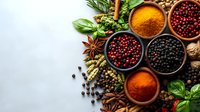 Aromatic spices and herbs in wooden bowls with peppercorns, turmeric, star anise, basil leaves and cinnamon sticks on rustic background with copy space.