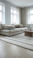 Minimalist Scandinavian living room with beige sofa, wooden coffee table, striped rug and natural light from large windows for modern home interior design.
