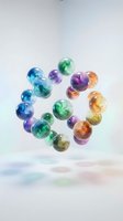 Colorful glass marbles with swirled patterns arranged in circle on white surface casting rainbow shadows for games and decoration projects.