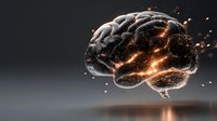 Glowing brain with orange light effects and particles floating against dark background, representing intelligence, mind power and cognitive function.