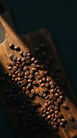 Roasted coffee beans scattered on rustic wooden cutting board with warm lighting creating rich brown tones and aromatic atmosphere for cafe branding.